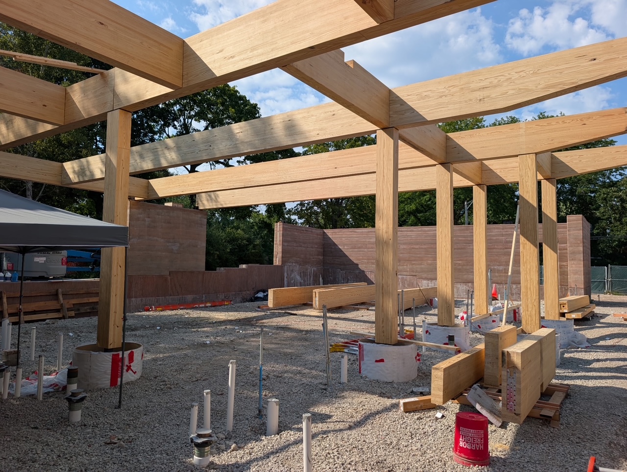 large timber beams criss cross the ceiling and into the ground