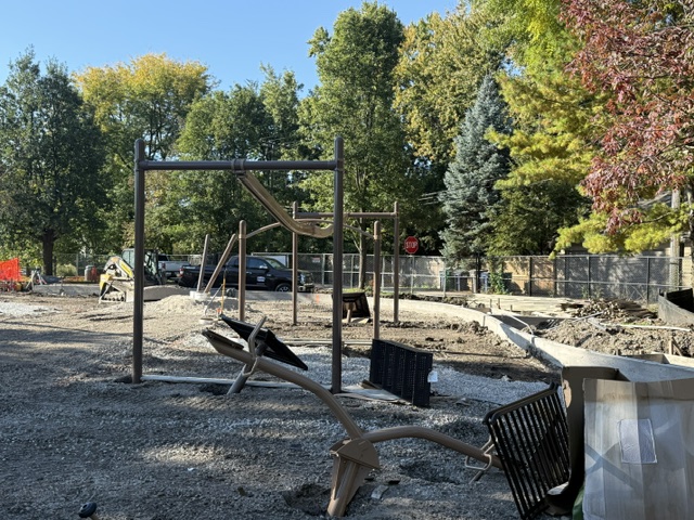 playground equipment lies around the construction site