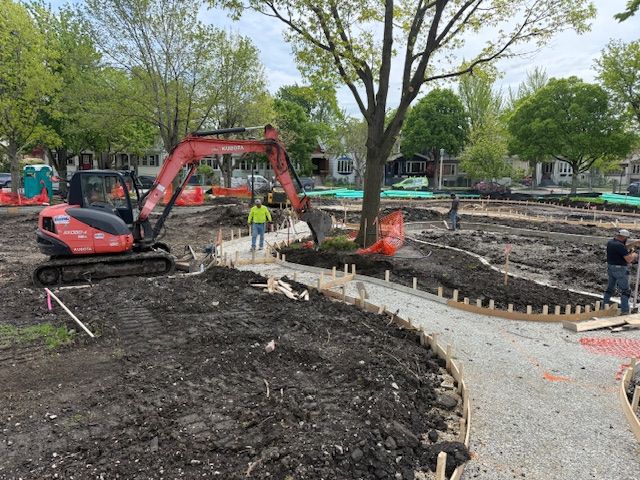 Construction at Longfellow Park (facilities_dir_ltg) with an excavator and workers preparing pathways.