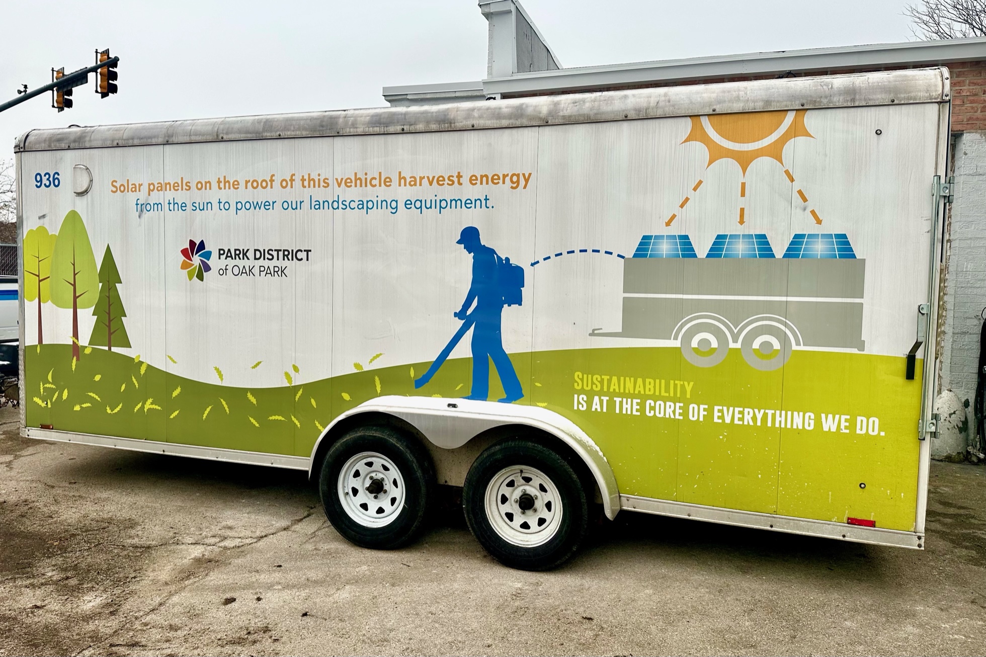 landscape trailer with information about how it uses solar to charge tools painted on the side